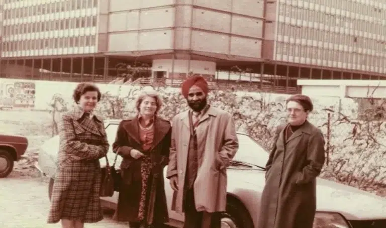 Hardev Singh Virk standing with his research group in front of a car at Marie Curie University, Paris (1977)